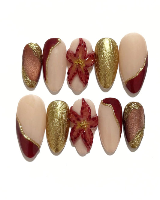 set de uñas press-on otoñal dorado y rojo burdeos con ojo de gato, cromático y flor 3D fondo blanco